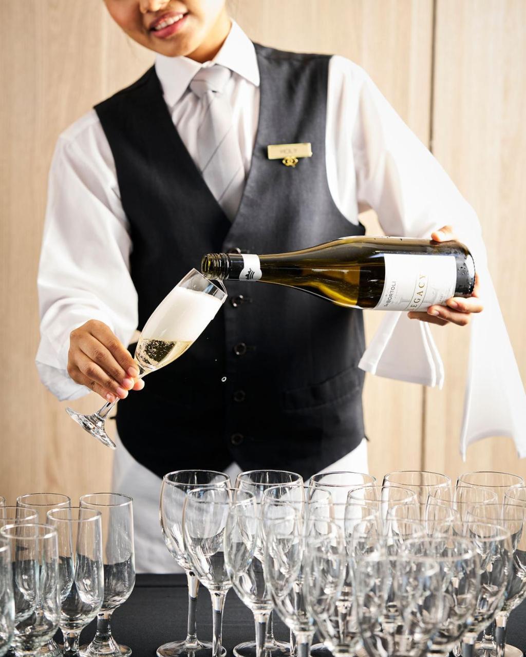 Готель Sofitel Melbourne On Collins Екстер'єр фото A sommelier pouring champagne