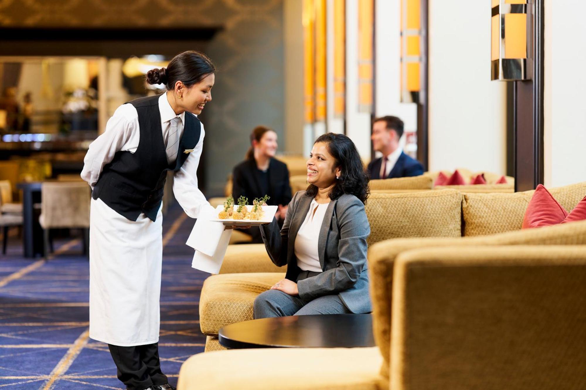 Готель Sofitel Melbourne On Collins Екстер'єр фото A hotel staff serving a guest